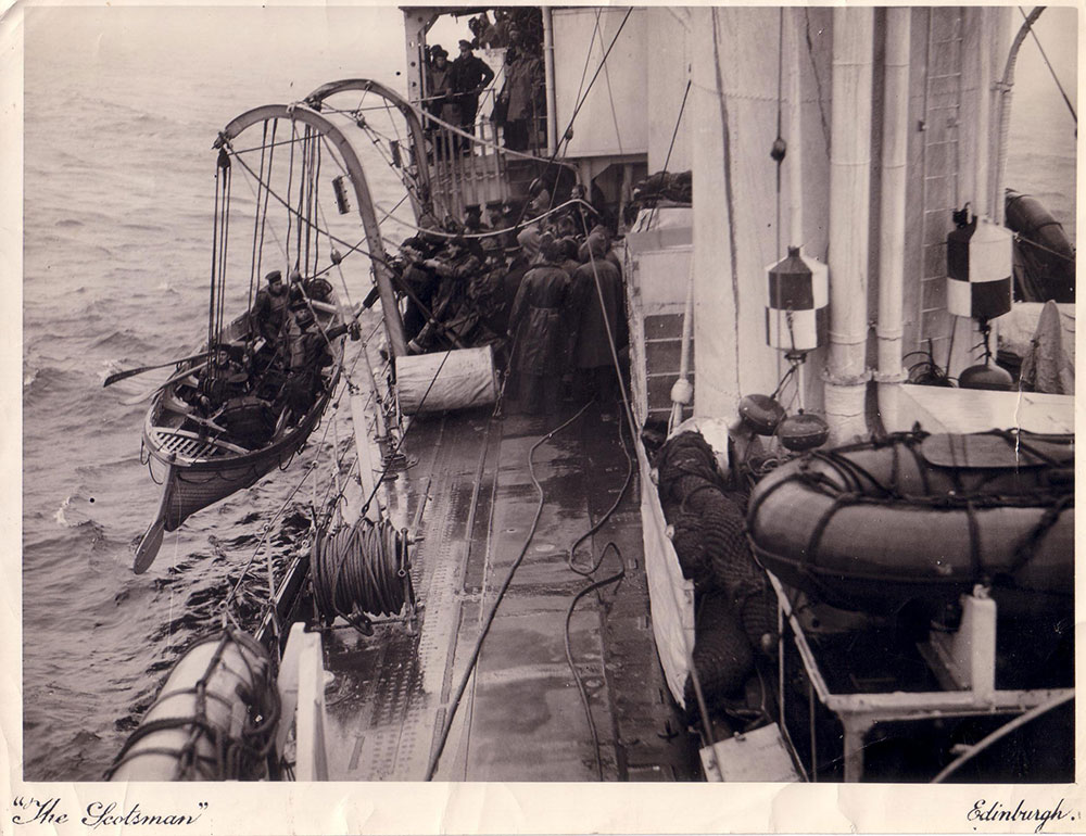 The whaler being lowered from the davits of HMS Vivien
