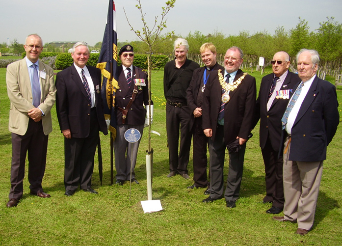 Plantingg a tree to honour the memory of the men who died when HMS Warwick sank